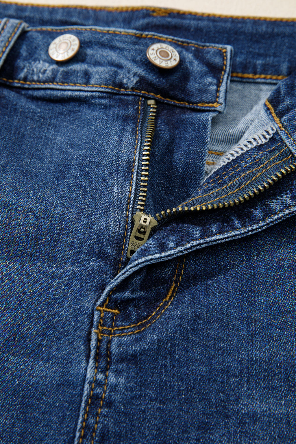Distressed Whiskery Denim Shorts With Asymmetric Raw Hem