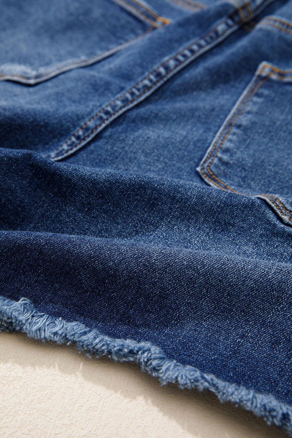 Distressed Whiskery Denim Shorts With Asymmetric Raw Hem