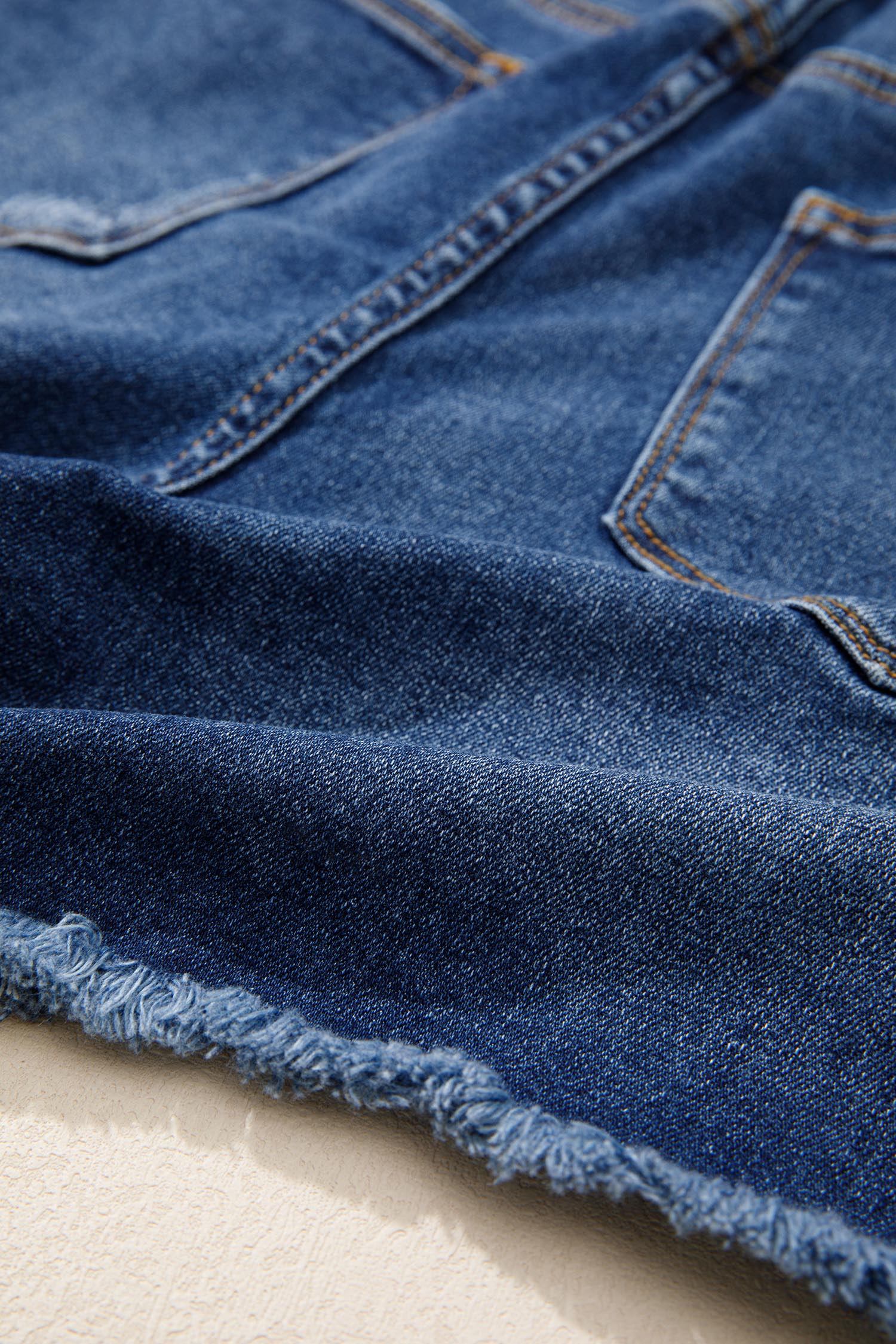 Distressed Whiskery Denim Shorts With Asymmetric Raw Hem