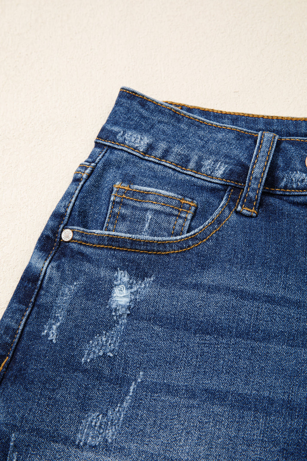 Distressed Whiskery Denim Shorts With Asymmetric Raw Hem