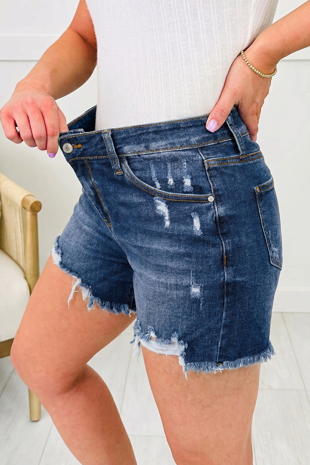 Distressed Whiskery Denim Shorts With Asymmetric Raw Hem