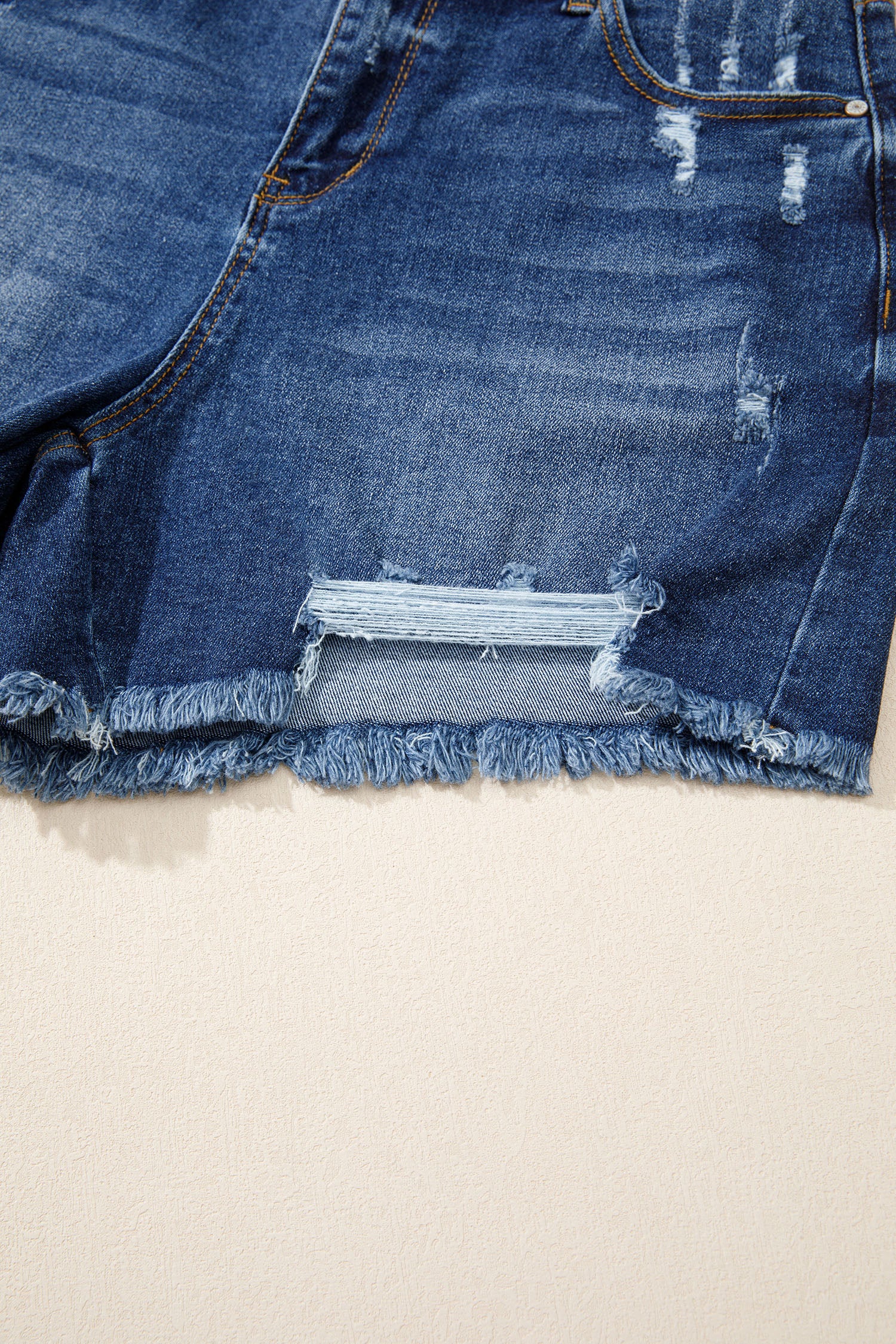 Distressed Whiskery Denim Shorts With Asymmetric Raw Hem