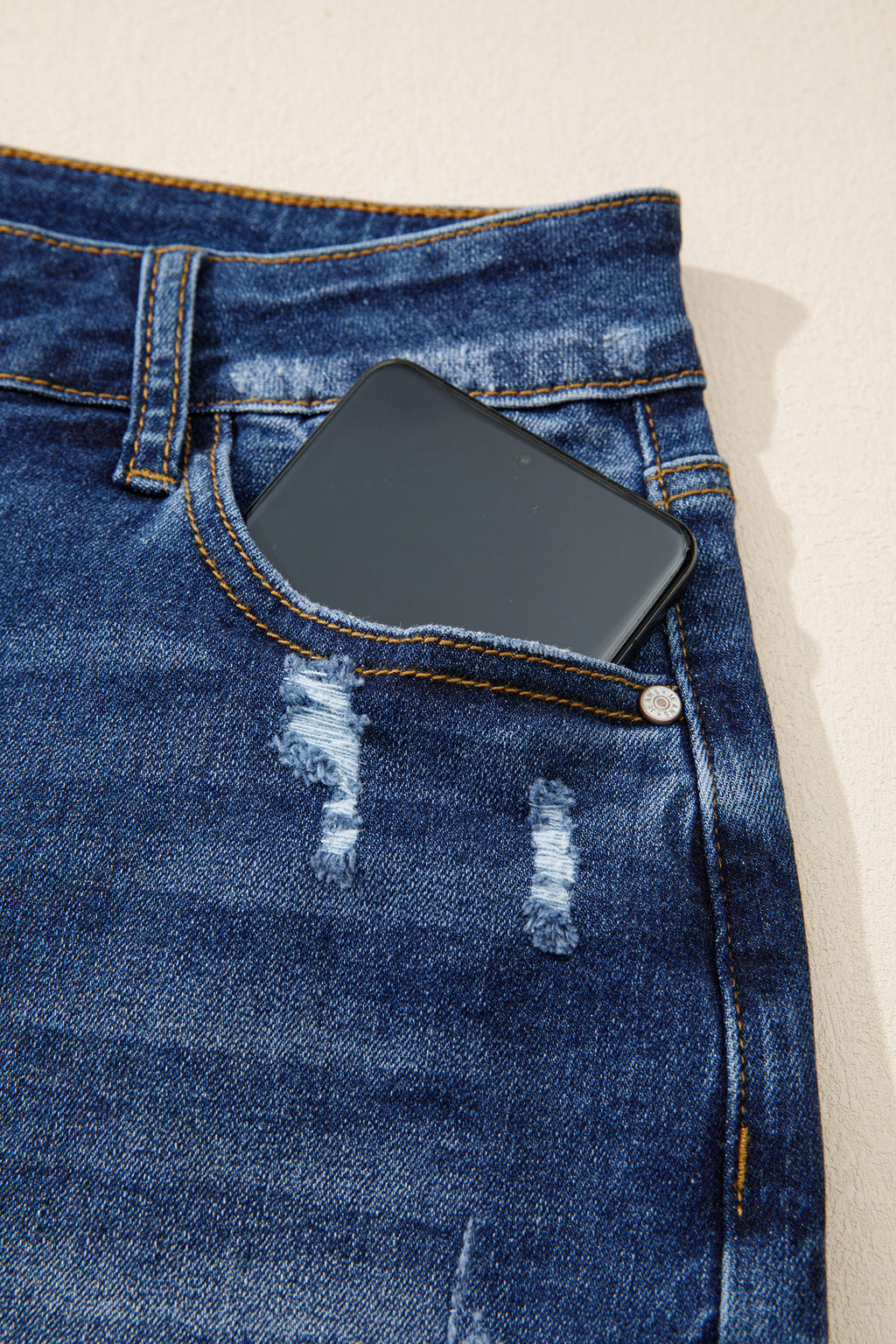 Distressed Whiskery Denim Shorts With Asymmetric Raw Hem
