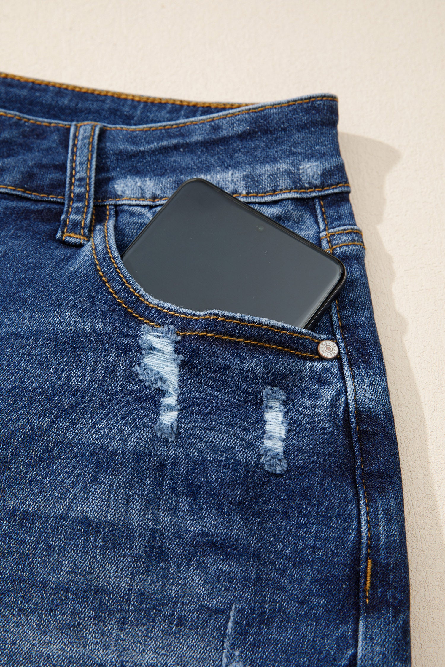 Distressed Whiskery Denim Shorts With Asymmetric Raw Hem