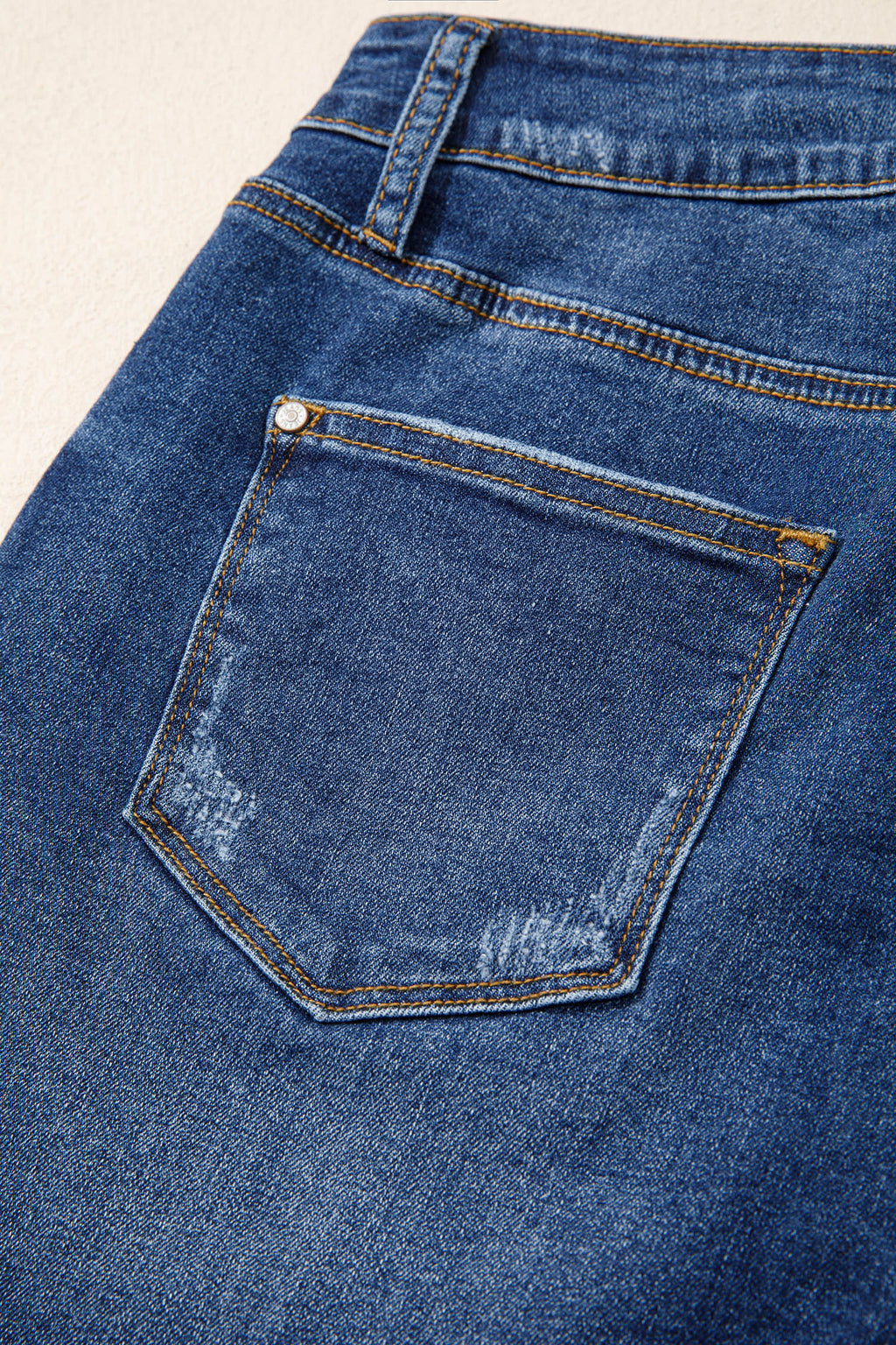 Distressed Whiskery Denim Shorts With Asymmetric Raw Hem